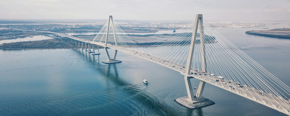 I shot this on a DJI Mavic Pro and edited in VSCO. This is one of my favorite architectural structures in Charleston, SC. This shot gives great perspective for how large the bridge actually is. I shot this at approximately 4:00p and the weather was overcast.. Photo by David Martin, Unsplash.